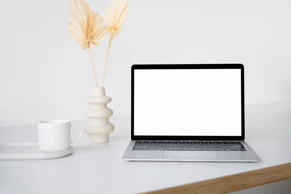 Dual monitors on a desk, showcasing web design in a modern office setting.